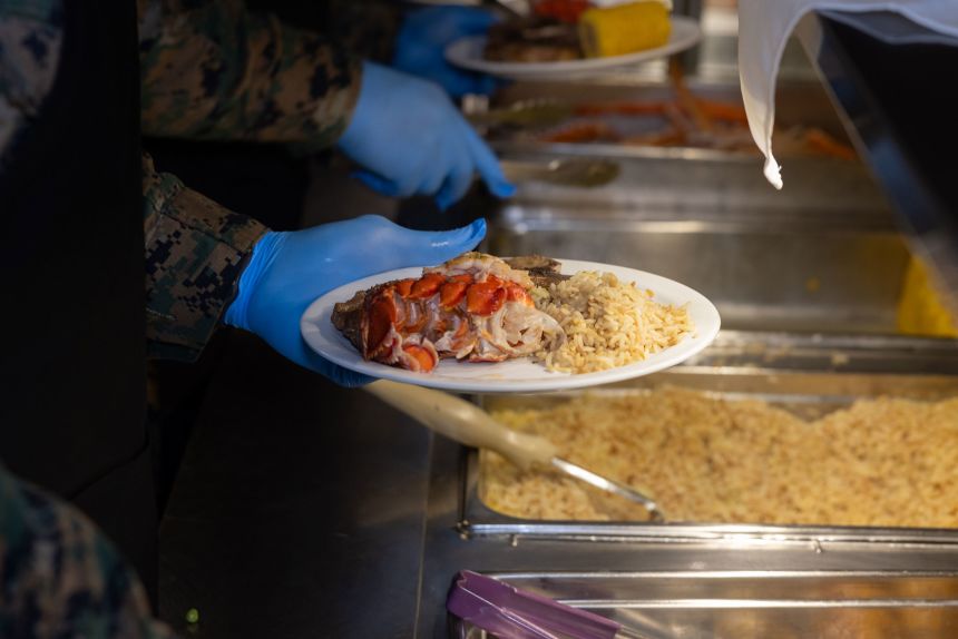 A US Marine serves lobster during the 249th Marine Corps Birthday meal at Mess Hall 488, Camp Foster, Okinawa, Japan, in November 2024.