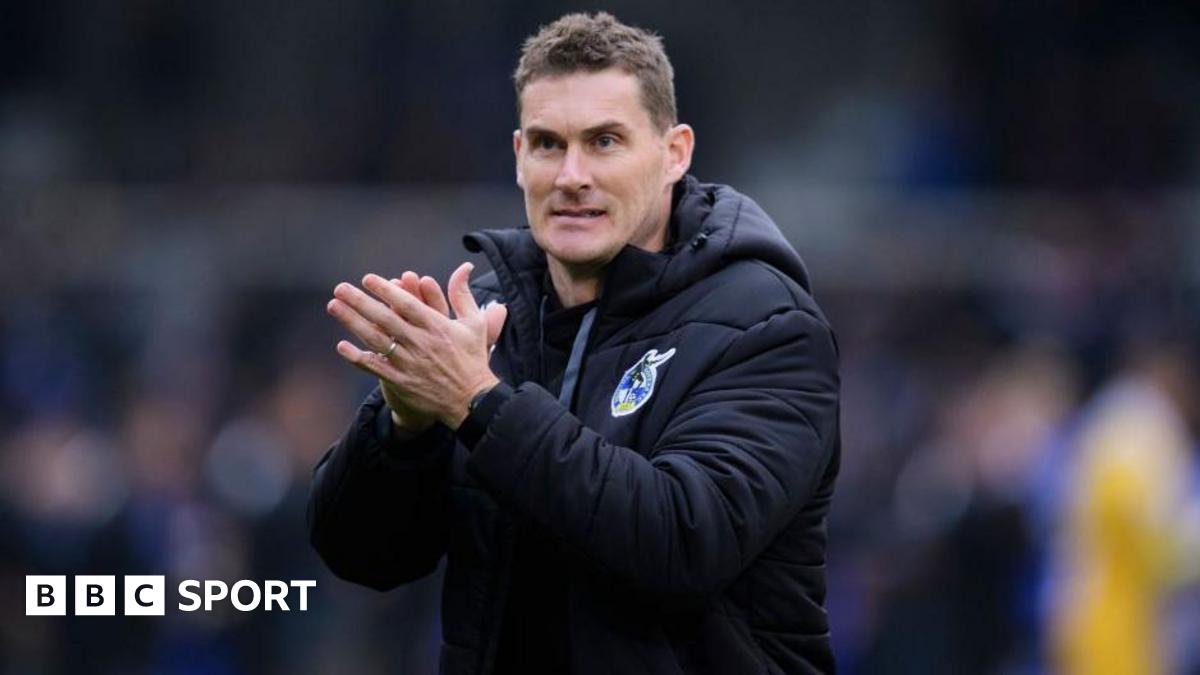 Matt Taylor applauds the fans while at Bristol Rovers in his club branded clothing