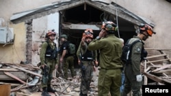 Israeli rescue personnel at a damaged building in the north of the country following missile fire from Hezbollah on March 13