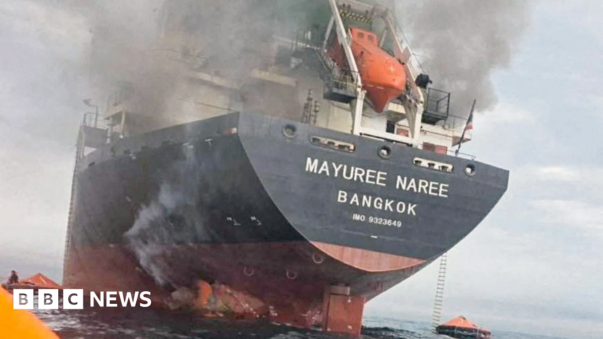 Smoke seen above a cargo ship with 'Bangkok' written on it