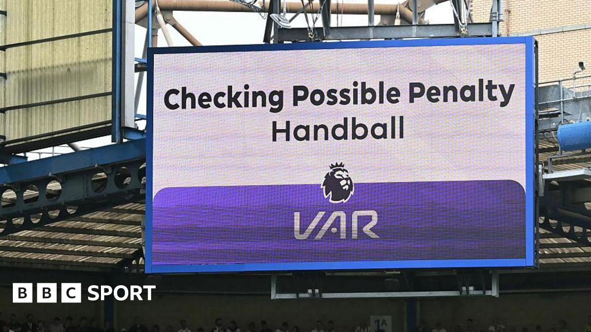 A big screen display a VAR check for a possible penalty during a Premier League match