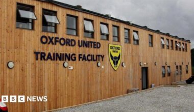 A wooden building with the Oxford United badge and the words "Oxford United Training Centre"