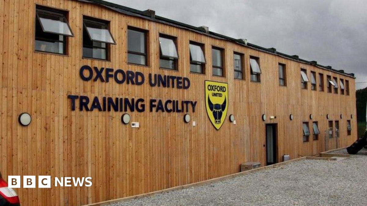 A wooden building with the Oxford United badge and the words "Oxford United Training Centre"