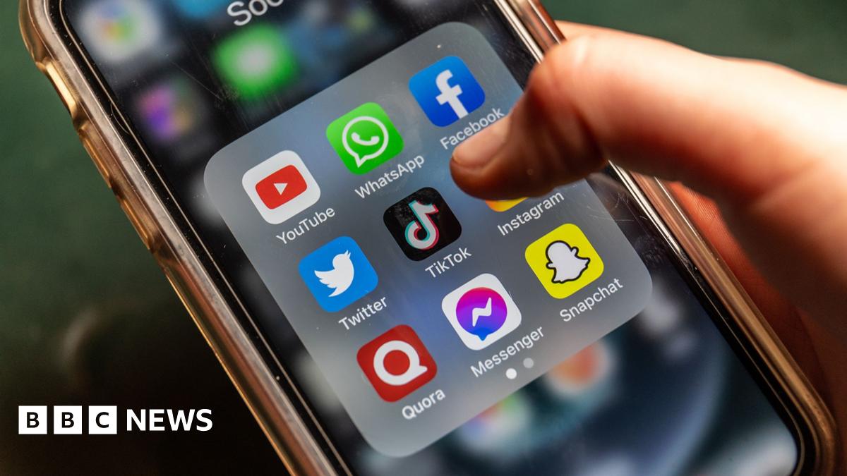 A phone screen showing several social media platforms with someone's finger hovering over TikTok icon