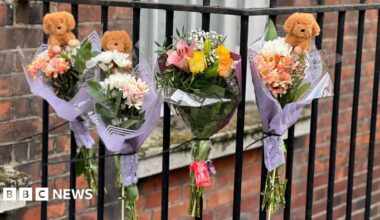 Pictures of flowers and a toy animal left near the Peabody Estate building in Horseferry Road in central London