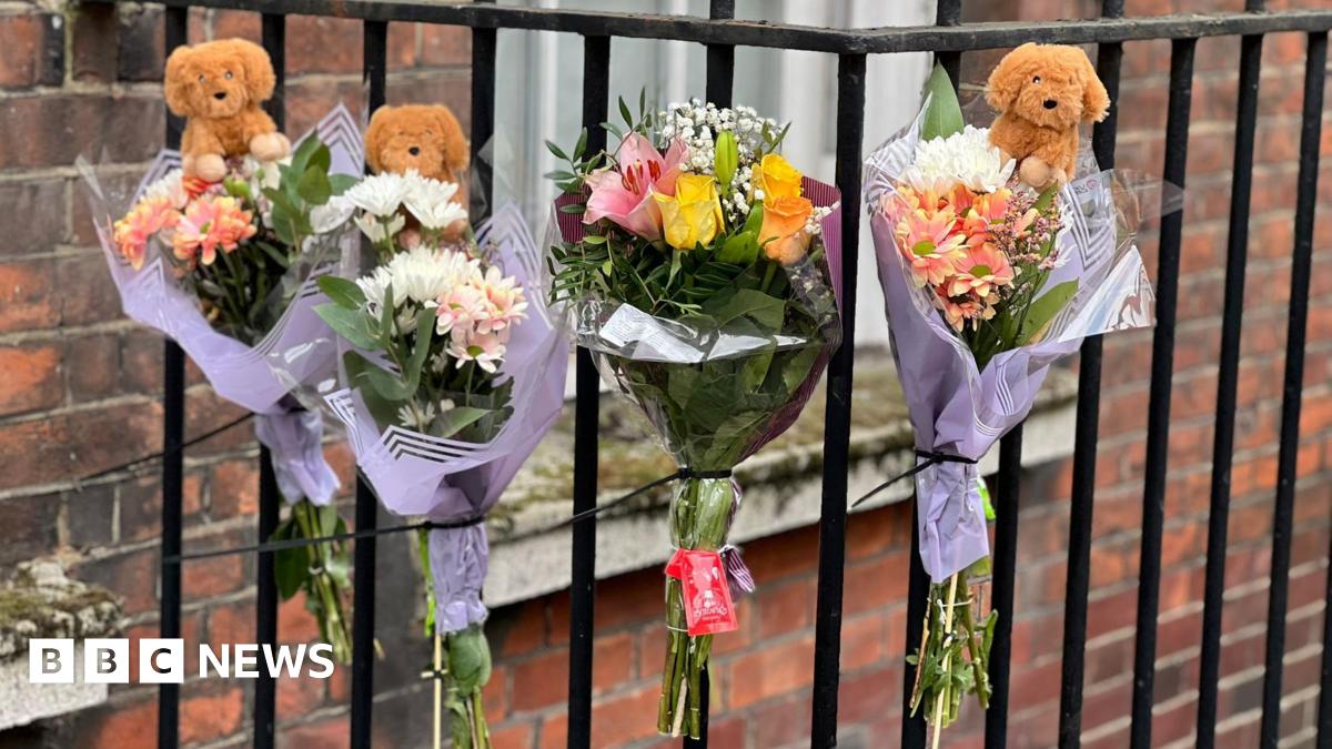 Pictures of flowers and a toy animal left near the Peabody Estate building in Horseferry Road in central London