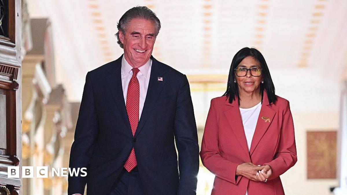 Venezuela's interim president, Delcy Rodriguez and US Interior Secretary Doug Burgum walk side by side