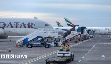 Emirates and Qatar Airways aircraft on the tarmac at I Gusti Ngurah Rai International Airport in Bali, Indonesia, after flight cancellations