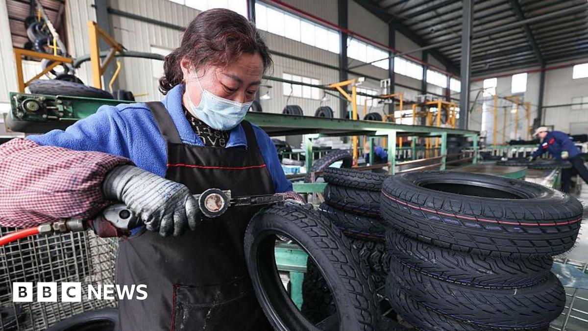 A woman processes tyre orders at a vehicle factory in China