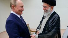 In this picture released by the official website of Iranian Supreme Leader Ayatollah Ali Khamenei, he and Russian President Vladimir Putin greet each other on July 19, 2022, during a meeting in Tehran, Iran.