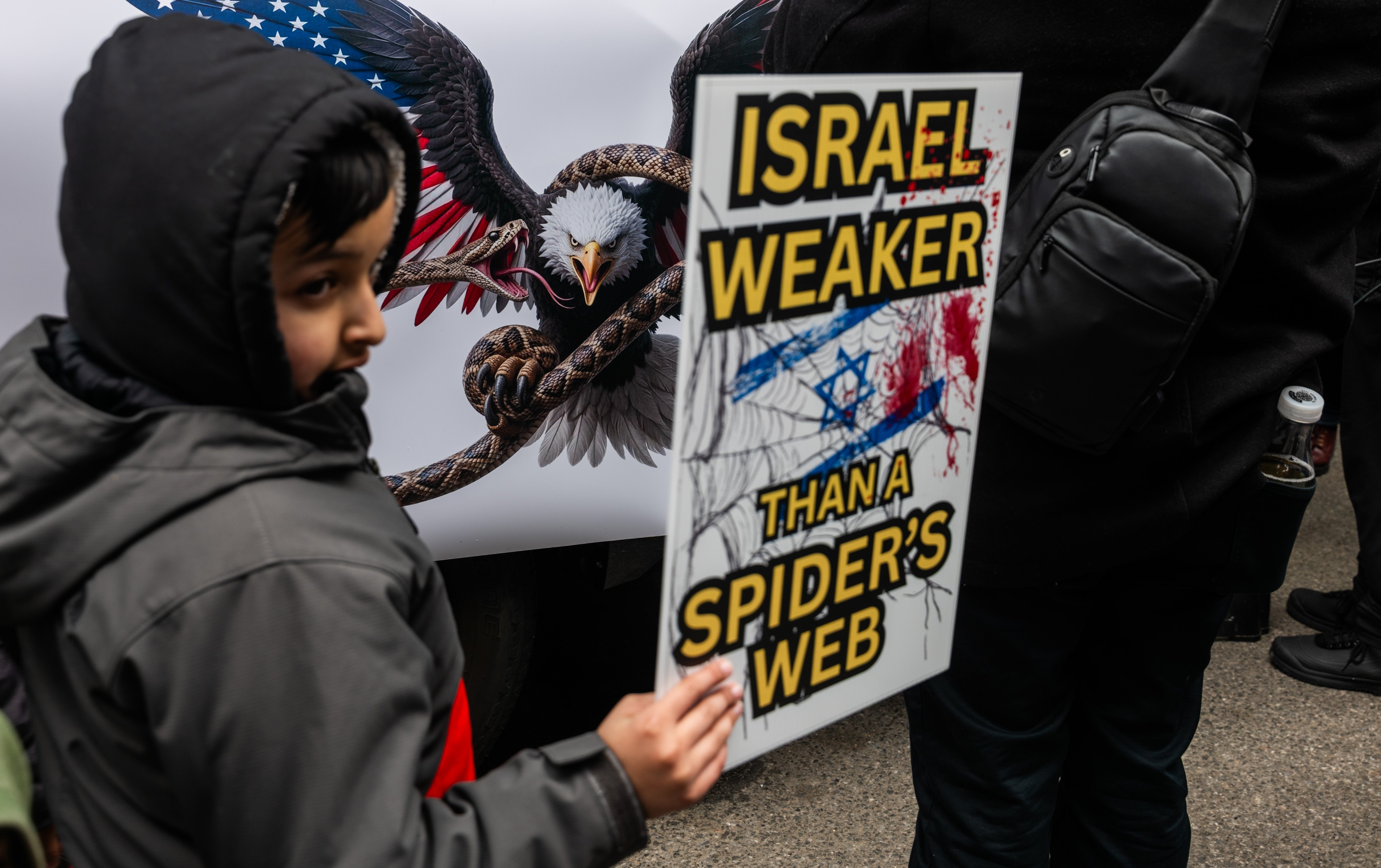 A child joins other protesters as they gather in Times Square for an Al Quds Day rally in support of Palestinians and against the current bombing of Iran by both the United States and Israel on March 13, 2026 in New York City