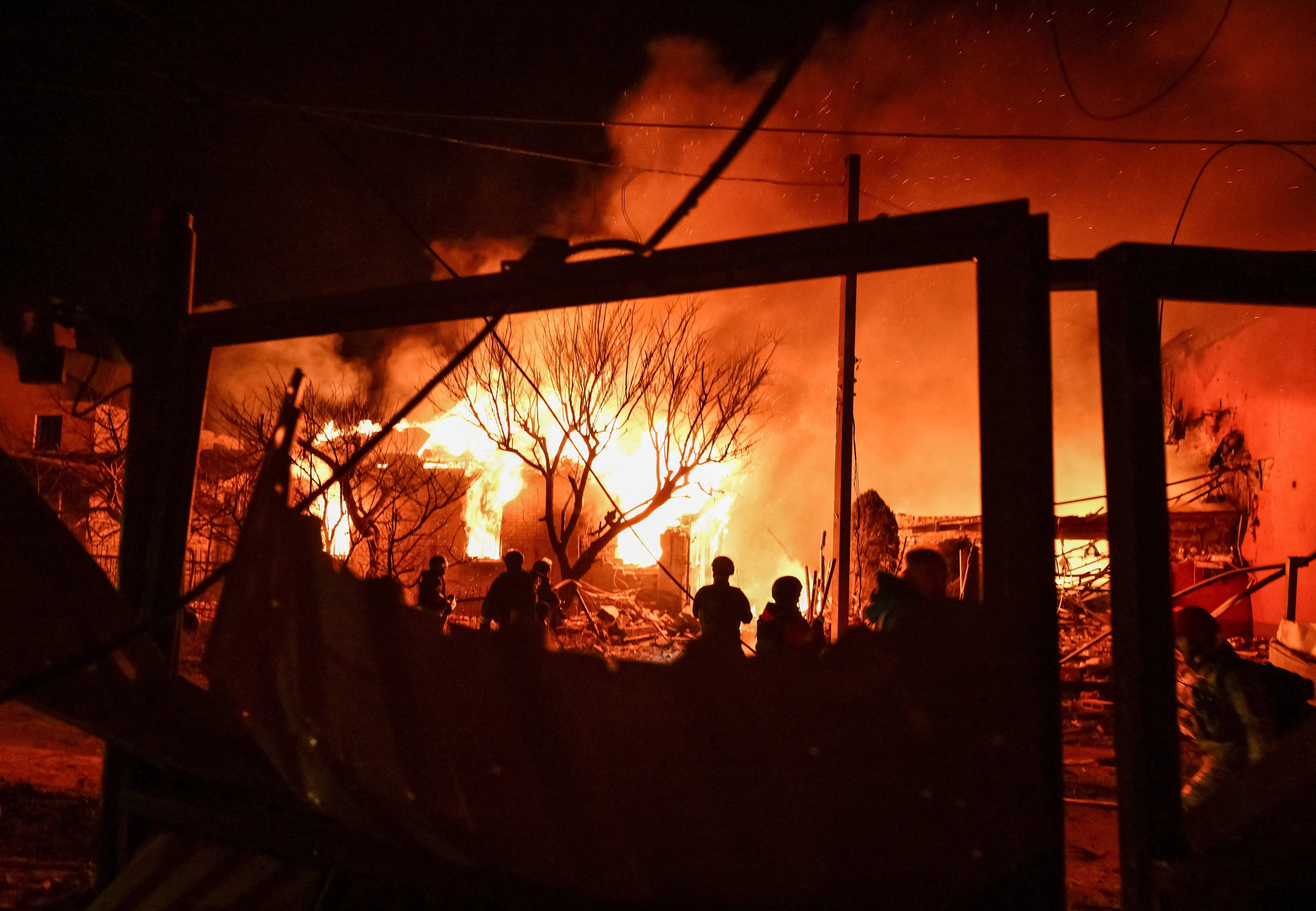 Firefighters work at the site of buildings hit by a Russian drone strike, amid Russia's attack on Ukraine, in Zaporizhzhia, Ukraine