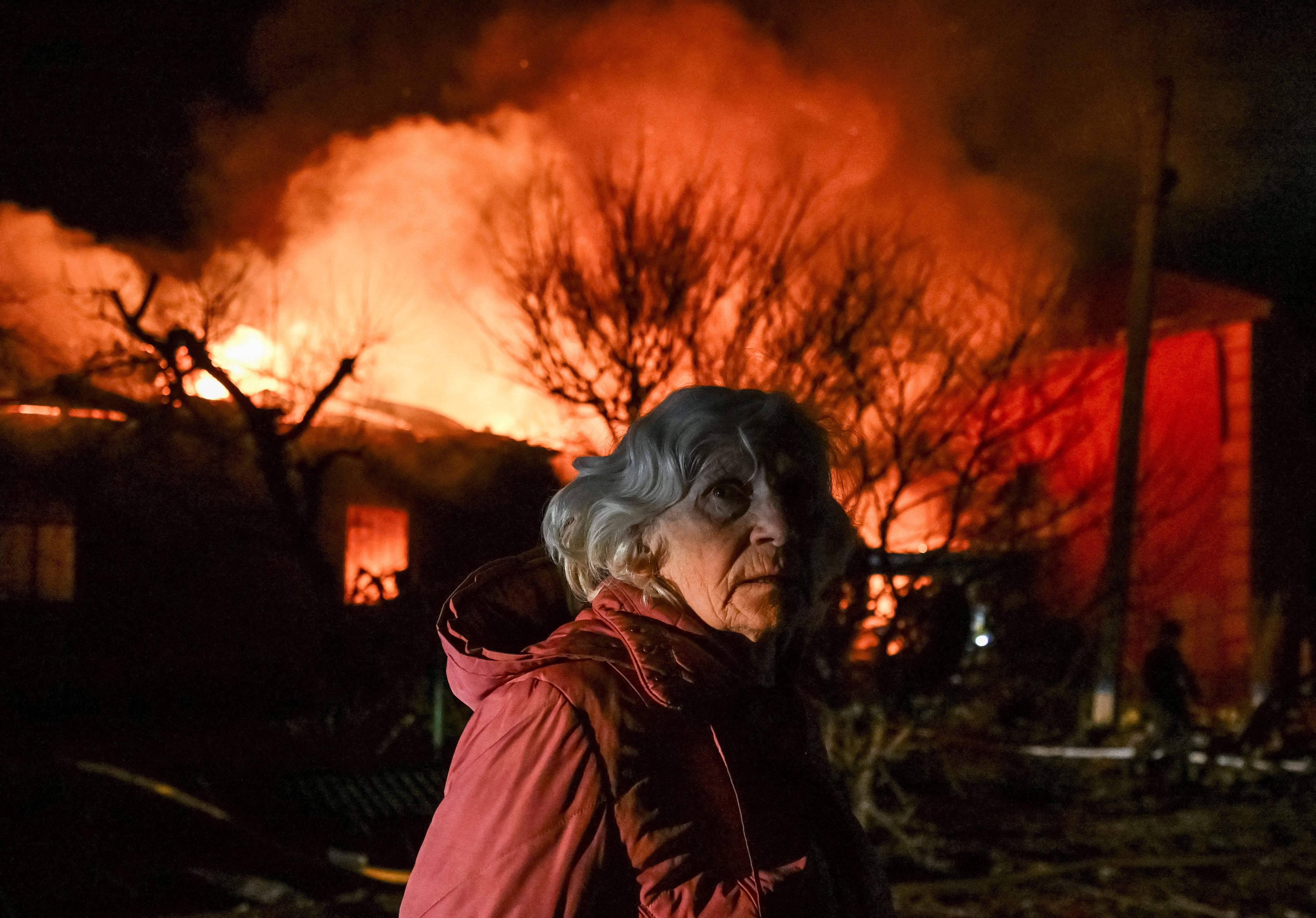 A resident stands at the site of buildings hit by a Russian drone strike, amid Russia's attack on Ukraine, in Zaporizhzhia