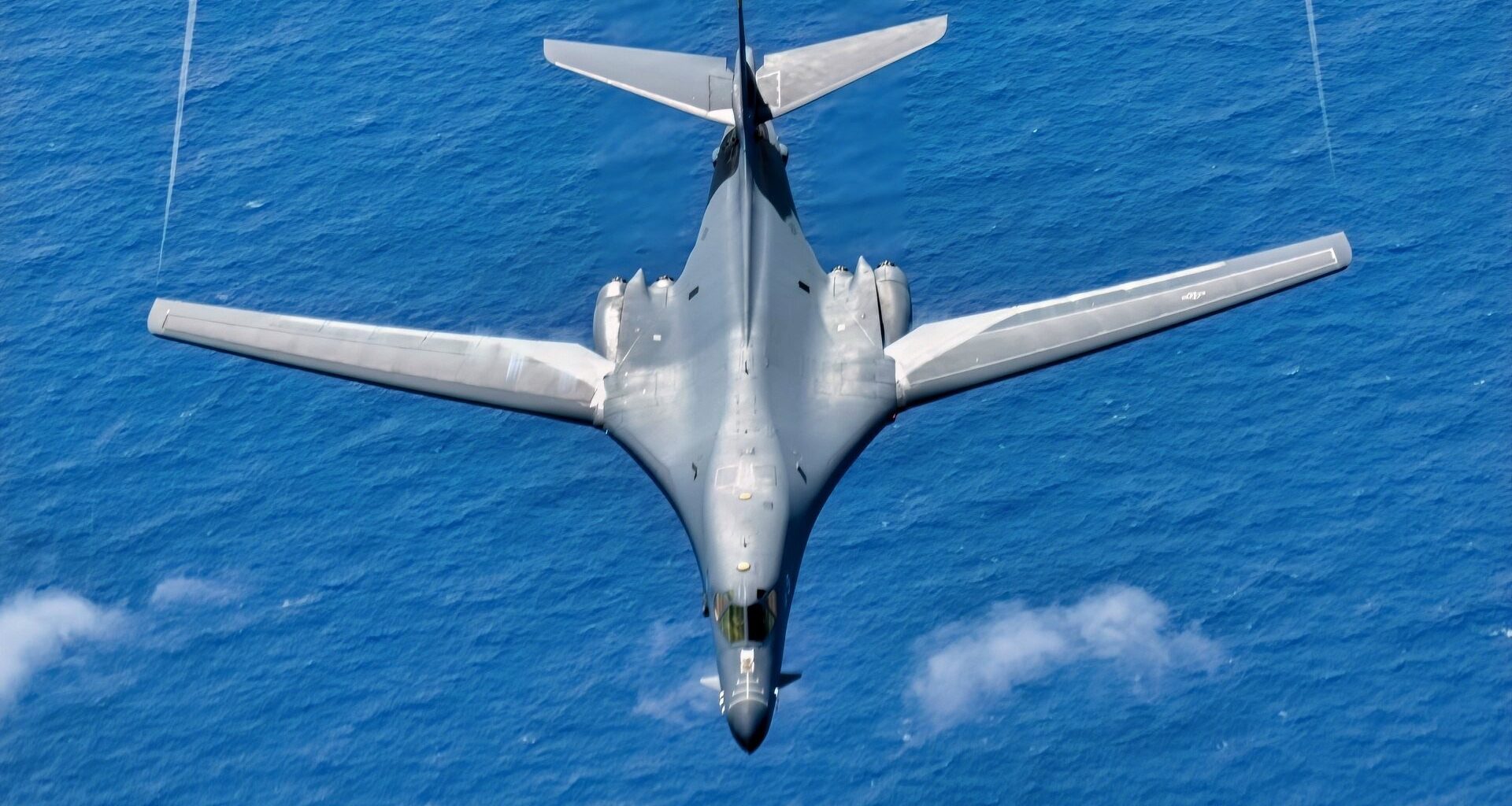 A U.S. Air Force B-1B Lancer assigned to the 34th Expeditionary Bomb Squadron, Ellsworth Air Force Base, S.D., descends after conducting aerial refueling with a KC-135 Stratotanker assigned to the 506th Expeditionary Air Refueling Squadron in support of Bomber Task Force 25-1 over the Pacific Ocean, Mar. 4, 2025. Bomber Task Force enhances readiness, to include joint and multilateral, to respond to any potential crisis or challenge in the Indo-Pacific. (U.S. Air Force photo by Airman 1st Class Alec Carlberg)