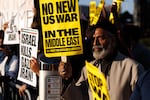 Demonstrators hold a sign reading "No New US War In The Middle East" during a protest against war in Iran in Houston, Texas, US, on Saturday, Feb. 28, 2026. Iran's supreme leader was killed in US-Israeli airstrikes, raising the stakes in a conflict that's spiraling across the oil-rich Middle East and disrupting traffic around the Hormuz shipping strait.