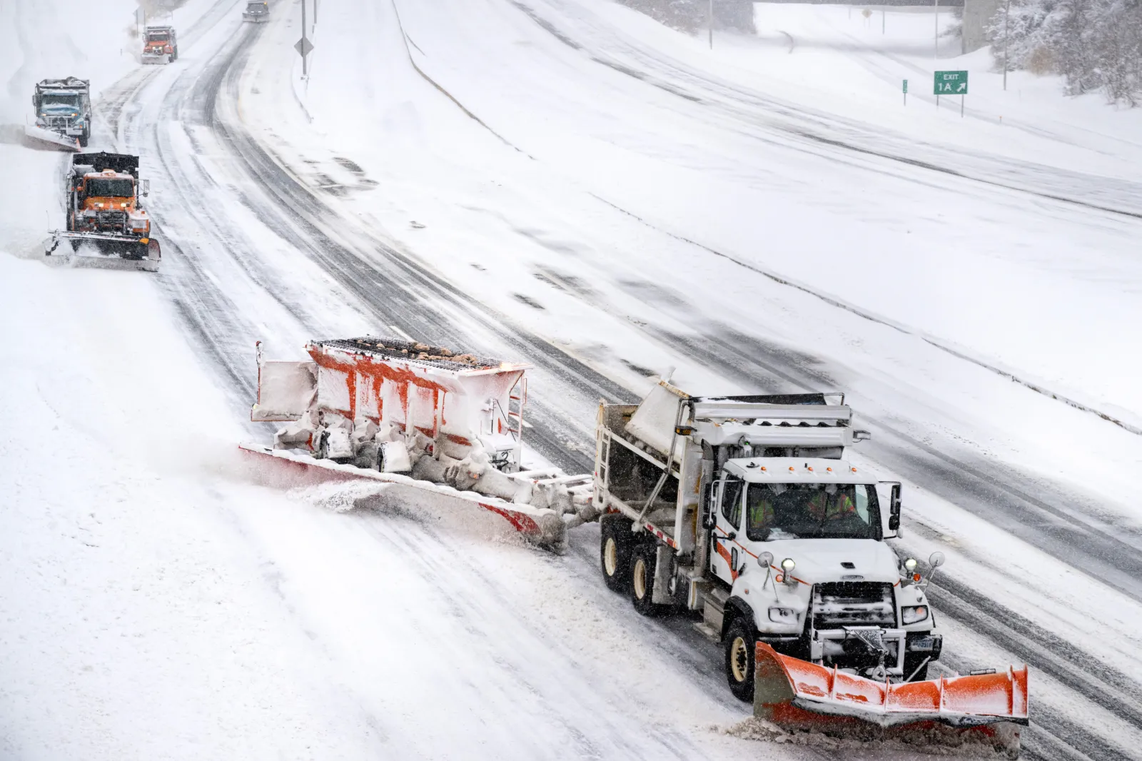 A parade of plows travels down I-384 in Manchester on February 23, 2026