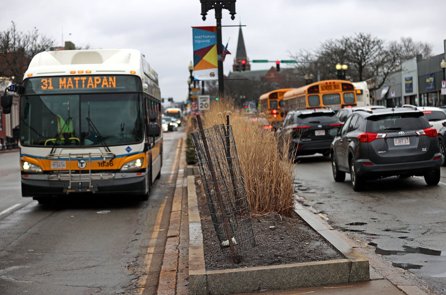 A view of the center line island on Blue Hill Avenue in Mattapan Square with traffic.