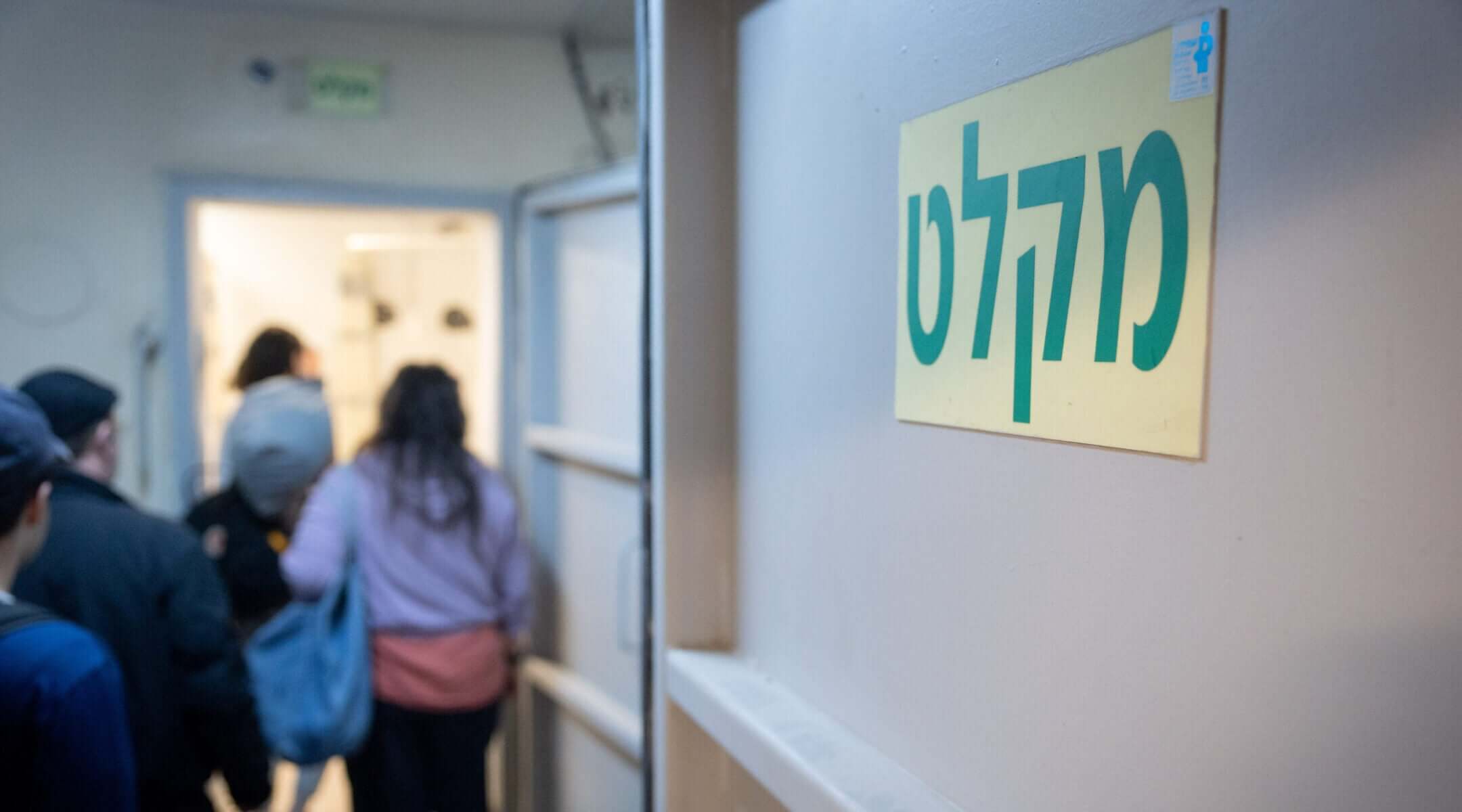 Israelis take cover in Tel Aviv as a siren sounds warning of incoming ballistic missiles fired from Iran toward Israel, March 1, 2026.