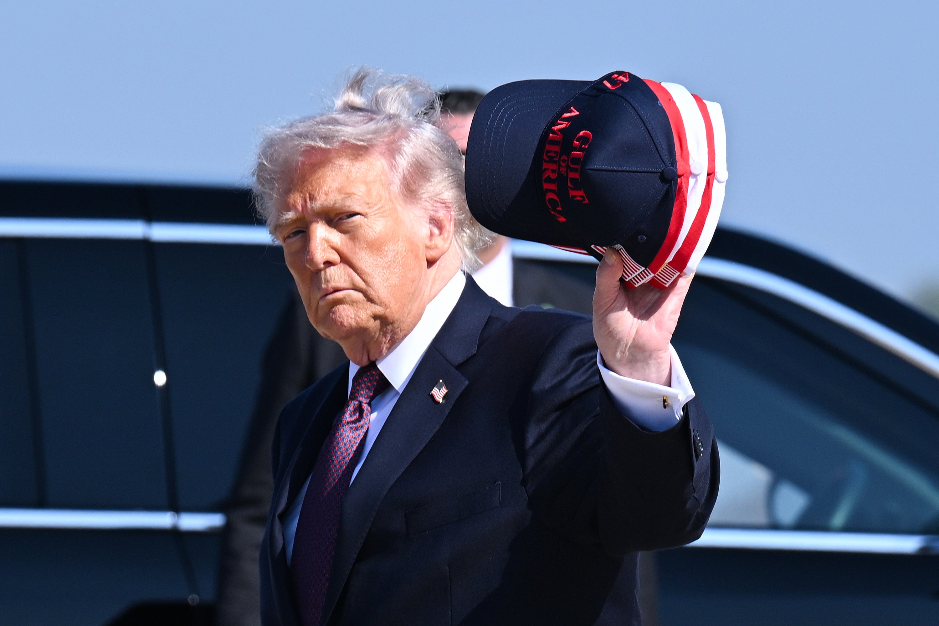 Trump was criticized for donning one of his signature branded caps during the ceremony, which was seen as disrespectful to fallen service members