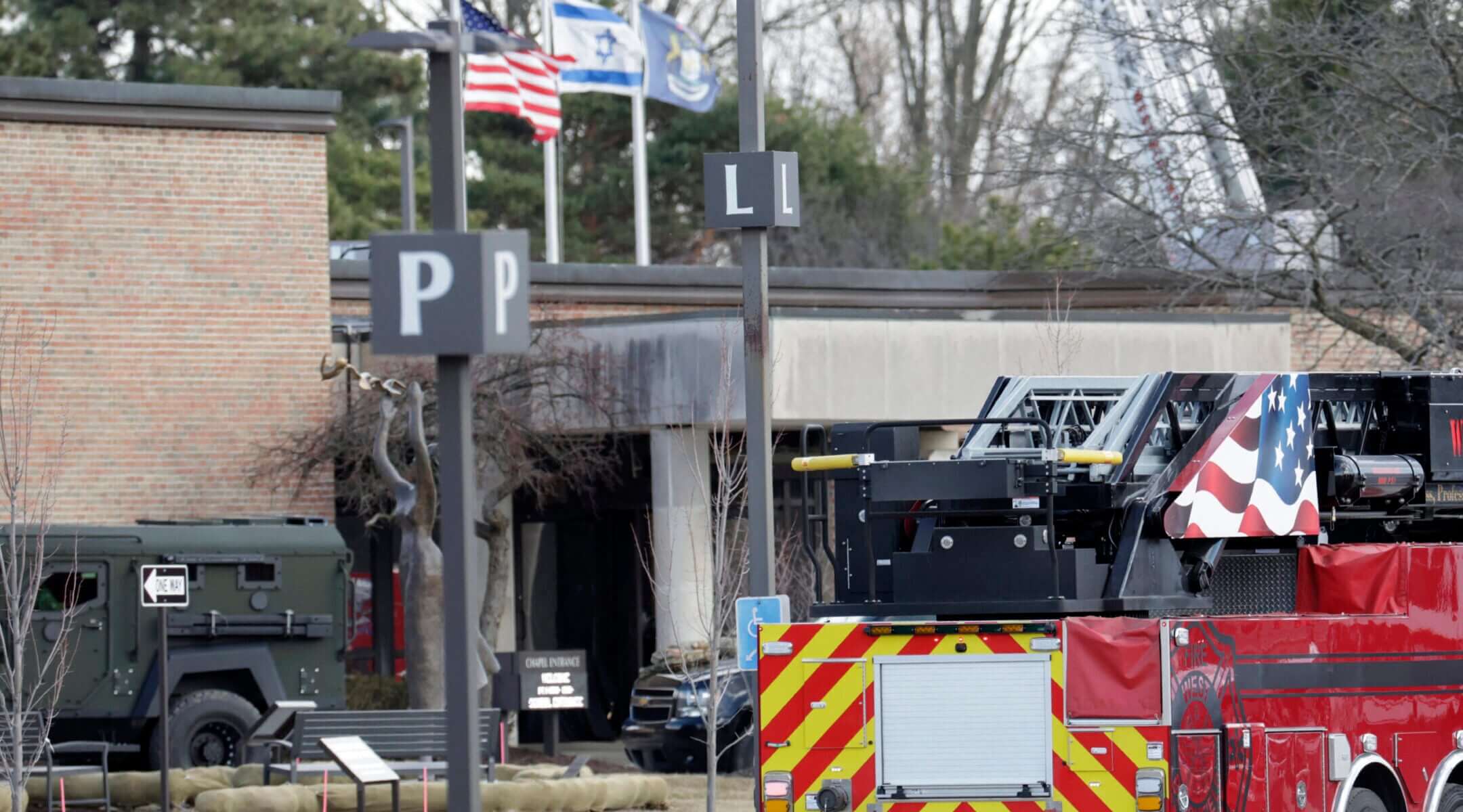 Law enforcement remain on site at the Temple Israel synagogue in West Bloomfield, Michigan, a Detroit suburb, on March 12, 2026, after an assailant drove a vehicle into the building. 