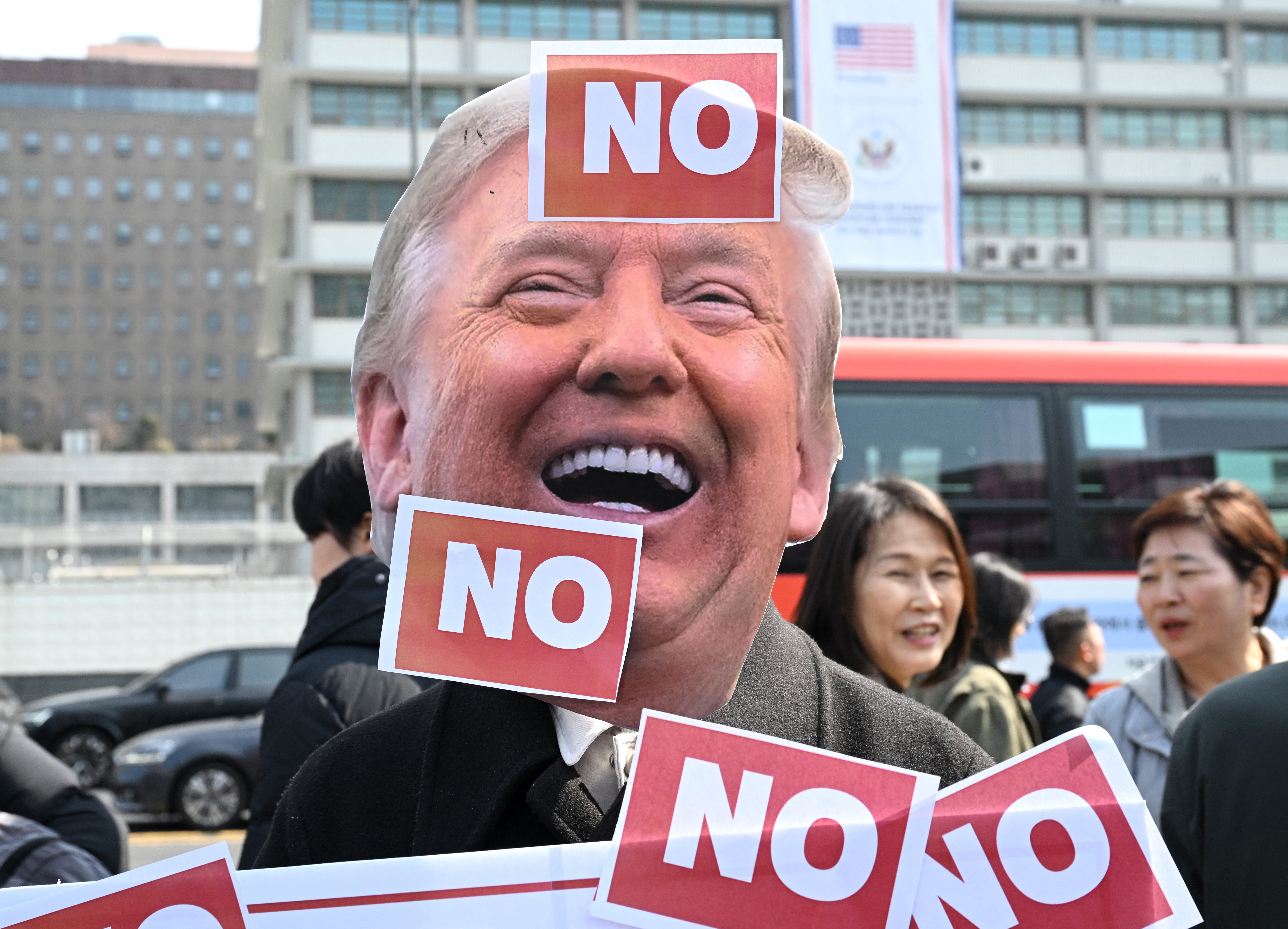 A South Korean protester wears a mask of US president Donald Trump during a protest against Trump’s request to dispatch warships to the Strait of Hormuz in front of the US embassy in Seoul on 16 March 2026