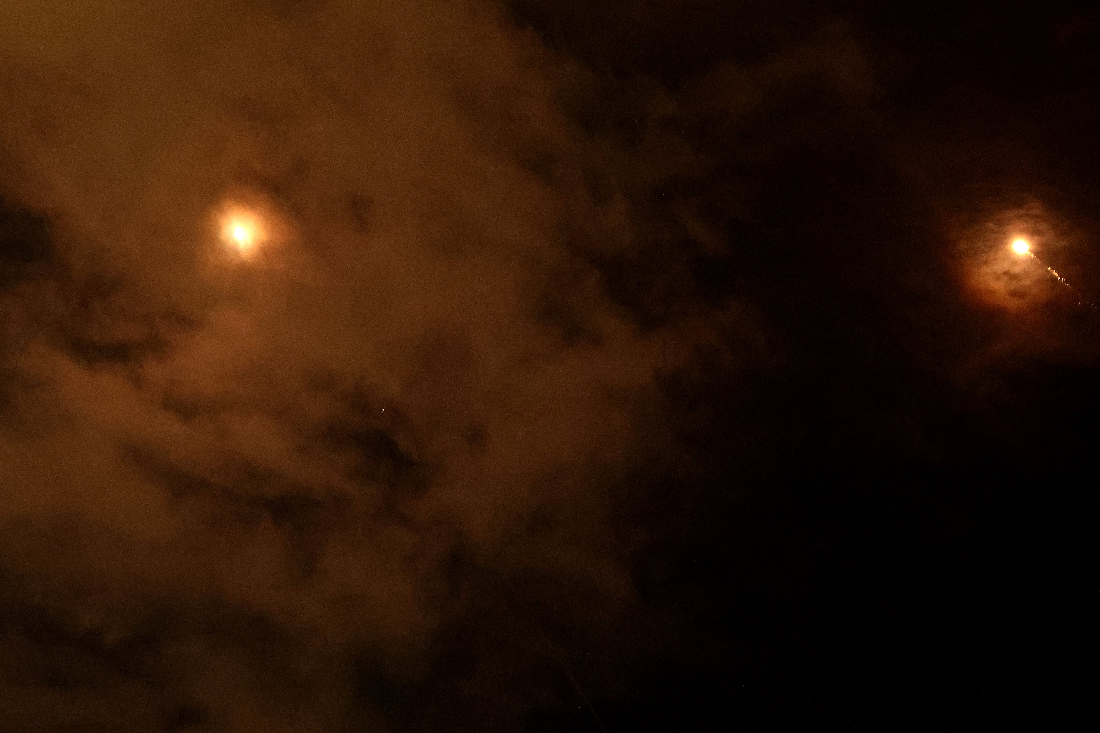 Rocket trails are seen in the sky above the Israeli coastal city of Netanya amid a fresh barrage of Iranian missile attacks on 25 2026