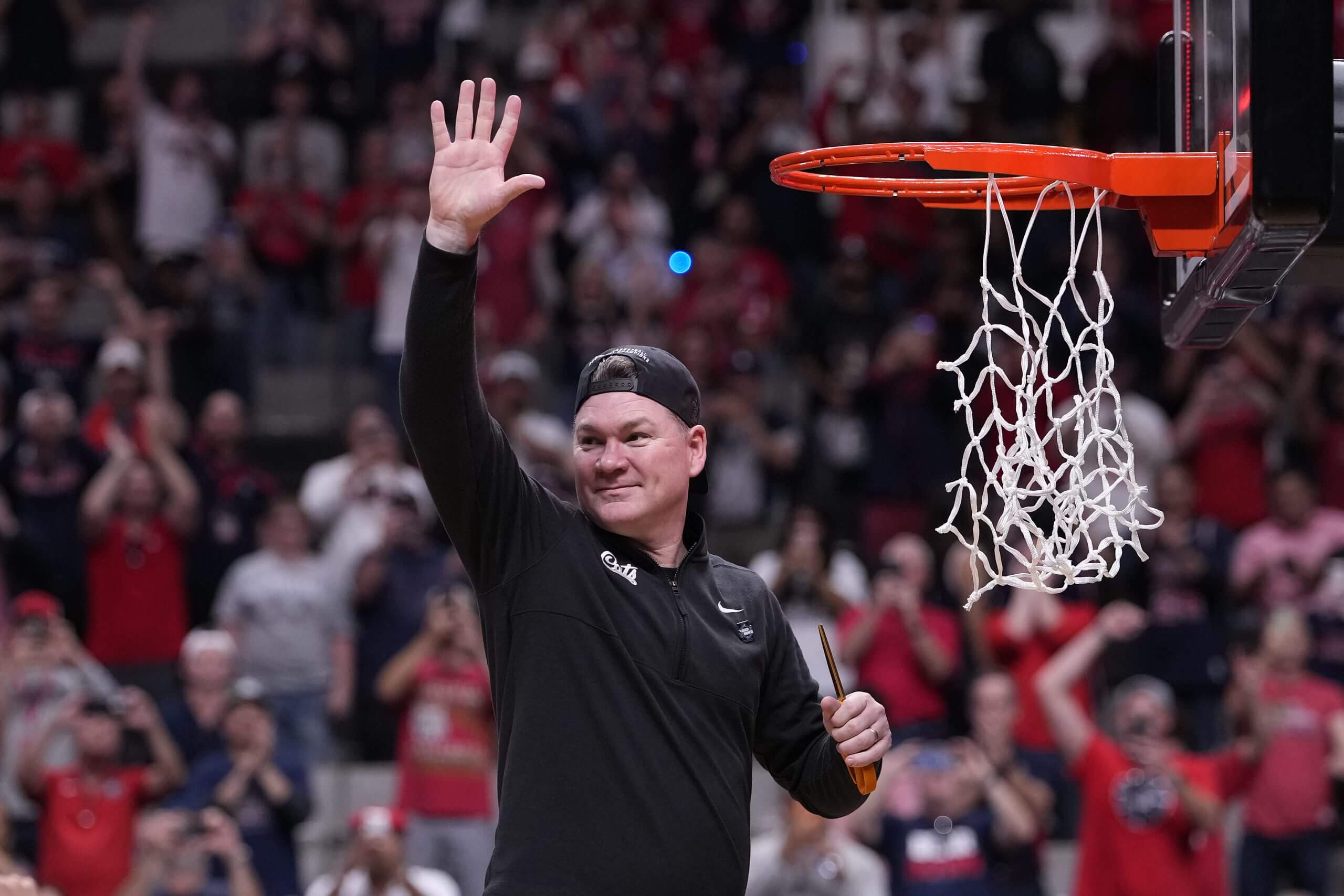 Arizona coach Tommy Lloyd cuts down the net after the Wildcats defeated Purdue 79-64 in the Elite Eight. (Thearon W. Henderson / Getty Images)