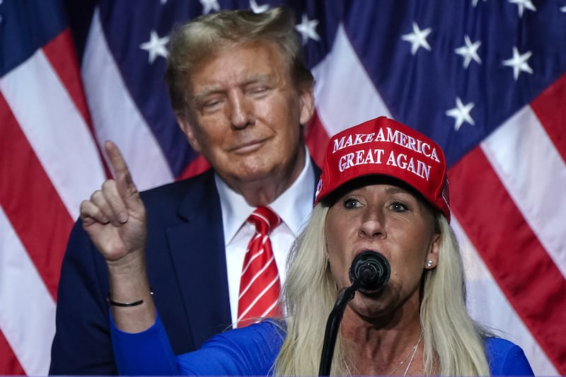 Marjorie Taylor Greene (R) speaks Donald Trump at a campaign event in Rome, Georgia, on March 9, 2024. (Photo by Elijah Nouvelage / AFP) (Photo by ELIJAH NOUVELAGE/AFP via Getty Images)