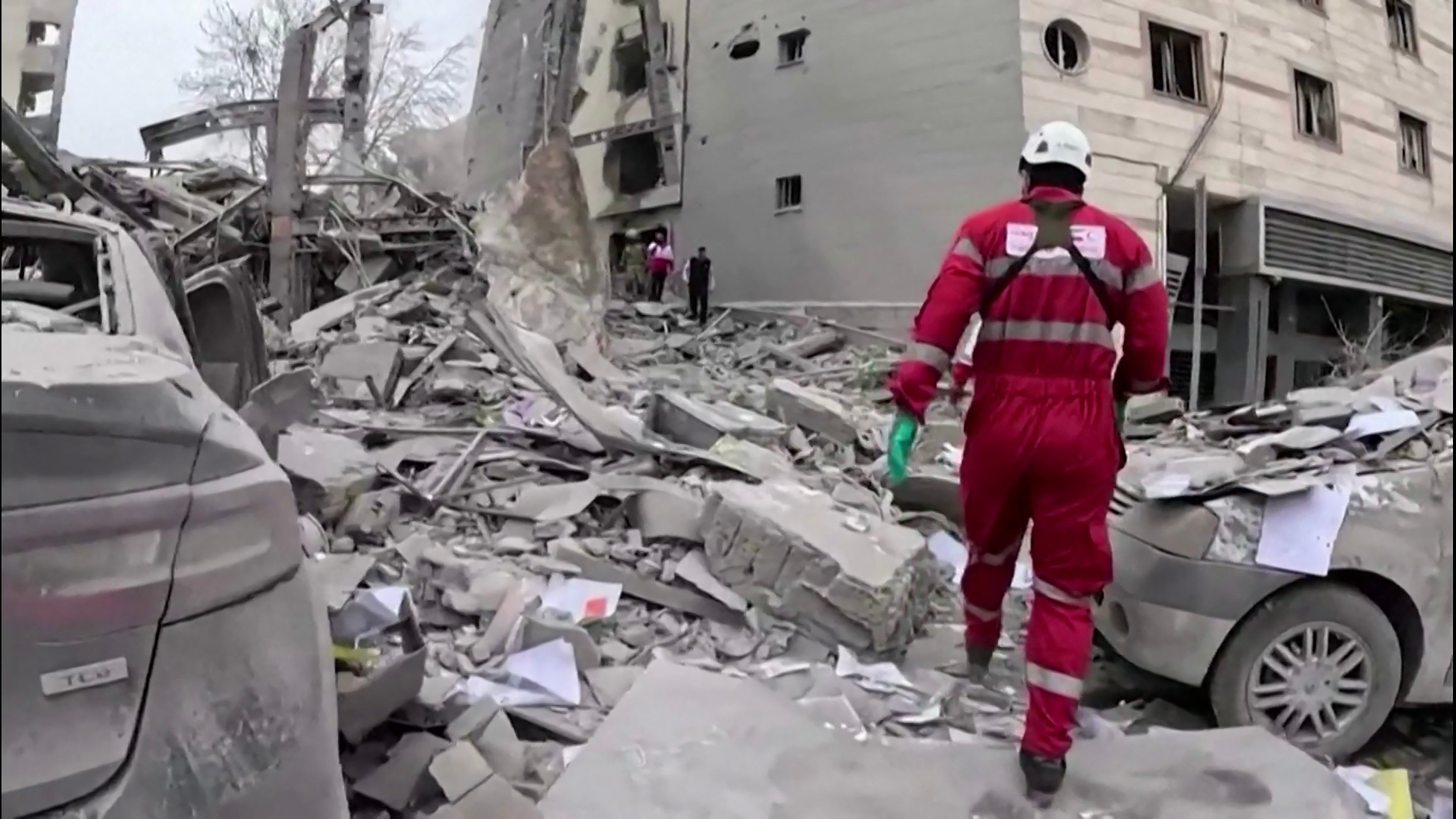 Rescuers at a site reportedly hit by US-Israeli strikes on Wednesday