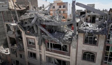 First responders inspect a residential building hit in an earlier US-Israeli strike in Tehran, Friday, March 27, 2026.