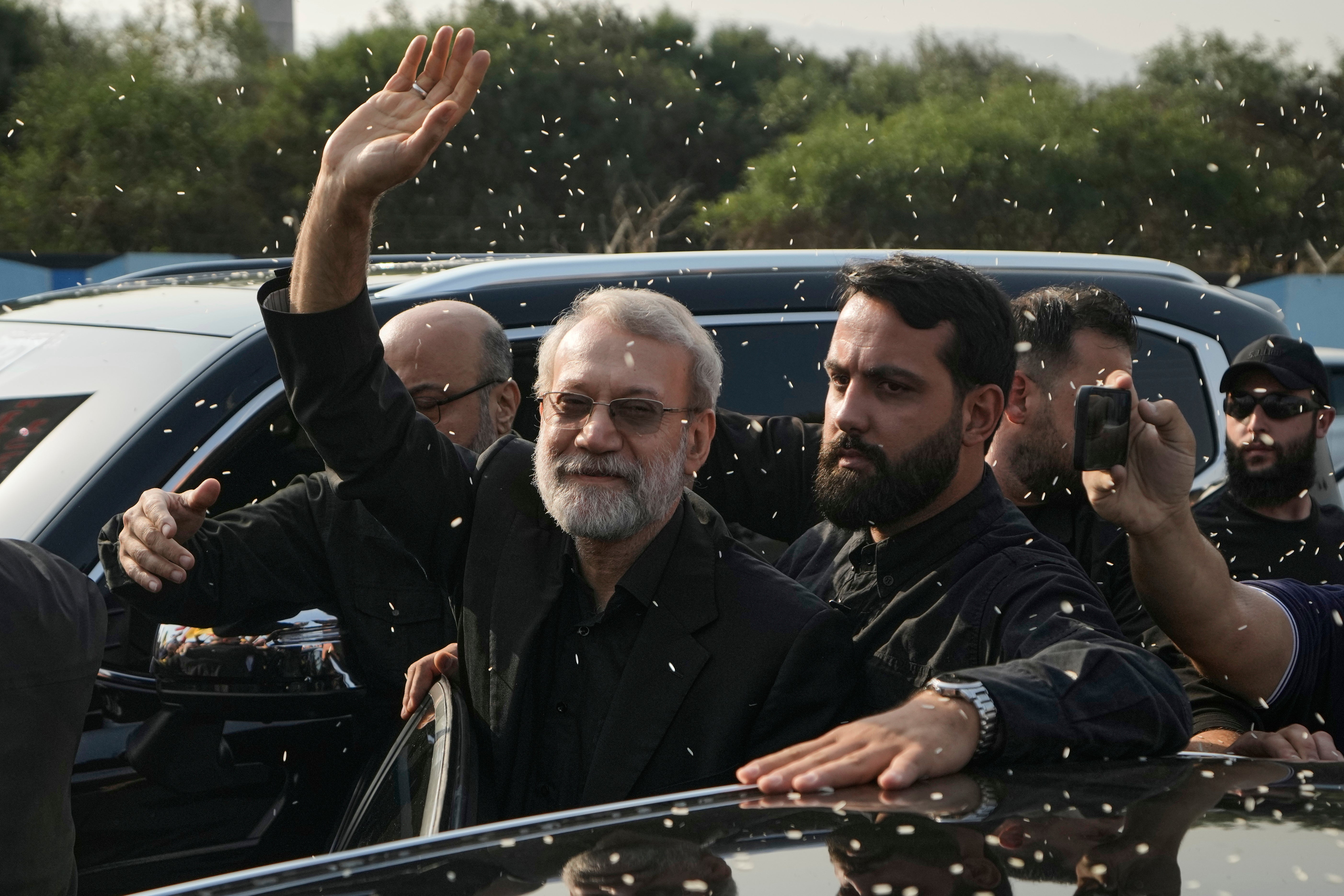 The late Ali Larijani, head of Iran’s National Security Council, gestures as Hezbollah supporters throw rice to welcome him outside Rafik Hariri International Airport in Beirut, Lebanon