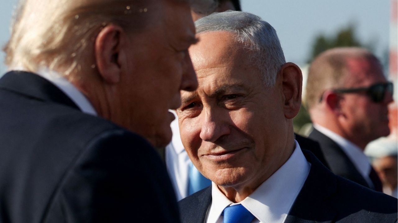Israeli Prime Minister Benjamin Netanyahu looks on next to U.S. President Donald Trump as Trump leaves Israel en route to Sharm El-Sheikh, Egypt, to attend a world leaders' summit on ending the Gaza war, amid a U.S.-brokered prisoner-hostage swap and ceasefire deal between Israel and Hamas, at Ben Gurion International Airport in Lod, Israel, October 13, 2025. (Reuters/Evelyn Hockstein)