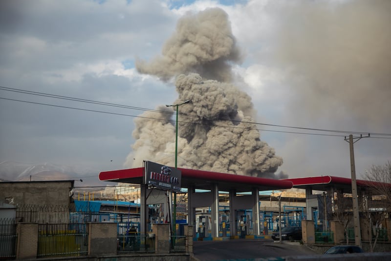 A plume of smoke rises after an explosion on March 2, 2026 in Tehran, Iran.