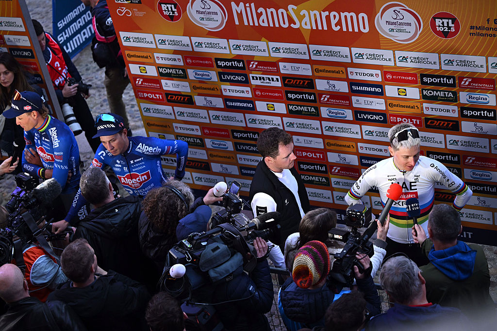 PAVIA, ITALY - MARCH 20: (L-R) Mathieu van der Poel of Netherlands, Jasper Philipsen of Belgium and Team Alpecin-Premier Tech and Tadej Pogacar of Slovenia and UAE Team Emirates - XRG during the team presentation prior to the 117th Milano-Sanremo 2026 / #UCIWT / on March 20, 2026 in Pavia, Italy. (Photo by Dario Belingheri/Getty Images)