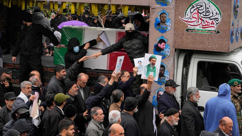 Iranians follow the funeral procession of Iran's intelligence minister Esmail Khatib and,...