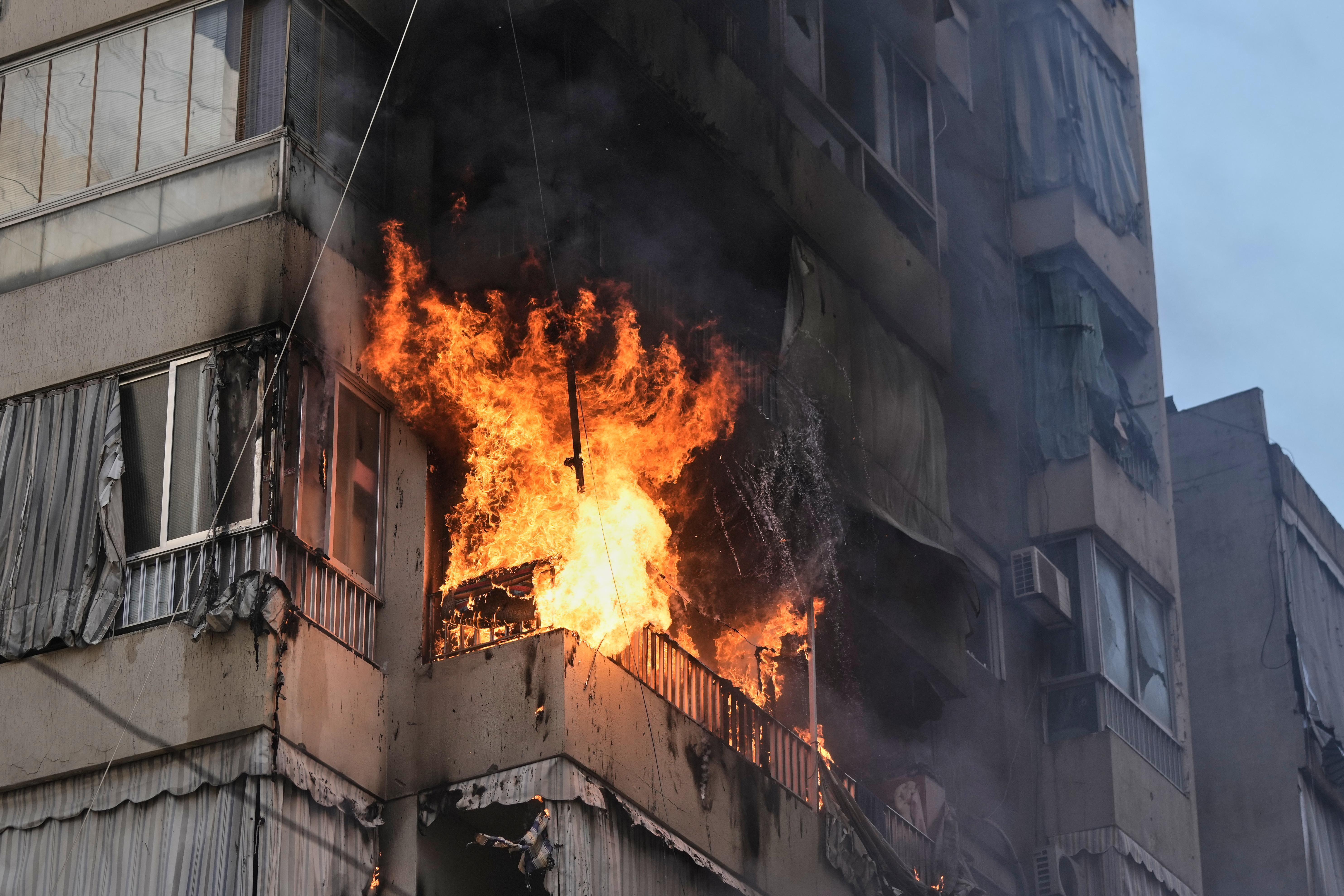 Smoke and flame rise from a residential building following an Israeli airstrike in central Beirut, Lebanon.