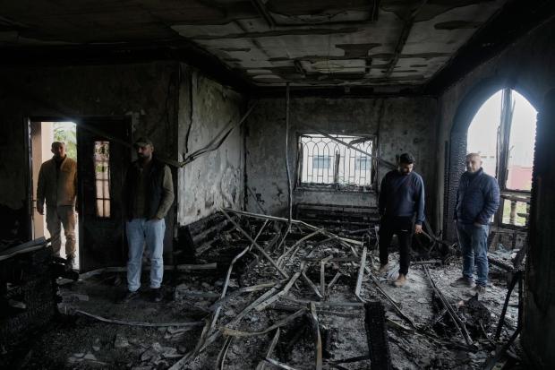 Palestinians inspect a torched house following Israeli settlers' rampage in the West Bank village.