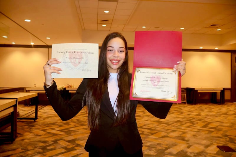 Melody Fernández, of Santo Domingo, Dominican Republic, displays her certificates after participating in the Harvard Model United Nations.