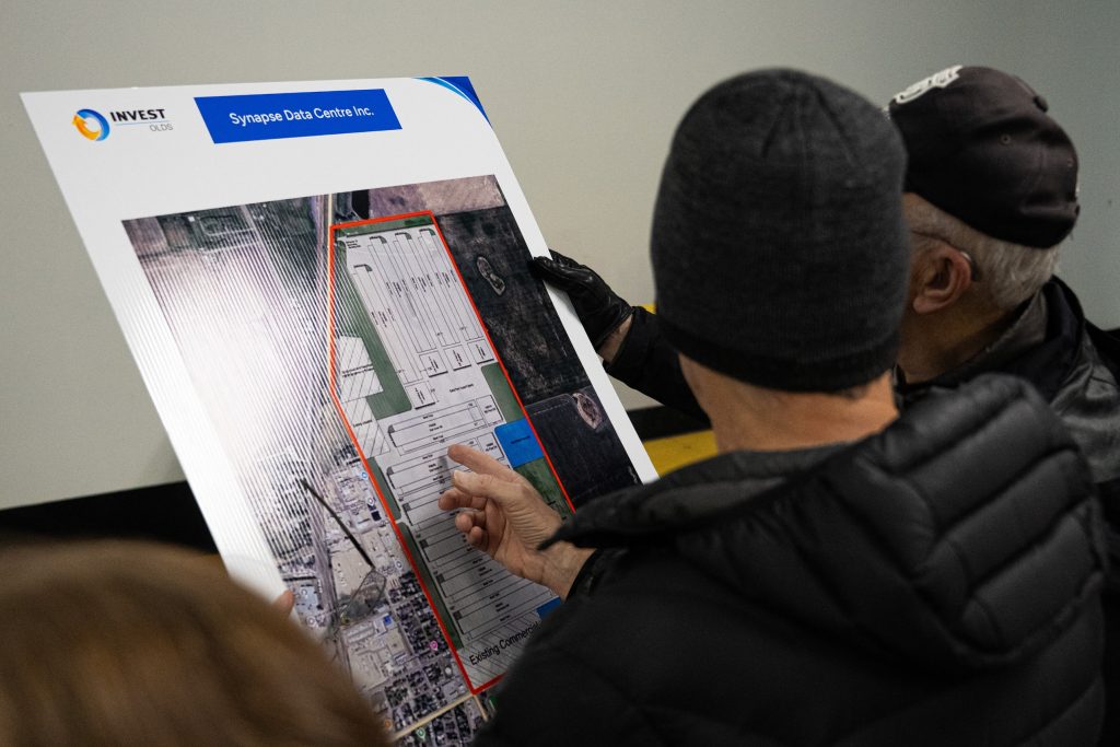 Residents look at a map showing a proposed data centre in Olds, Alberta.