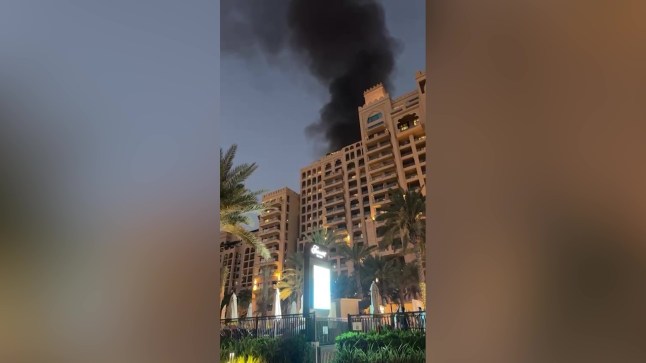 ** CONTRIBUTOR REQUESTS NO USAGE BY THE SUN ** Video grab from footage as a British couple on honeymoon in Dubai were left terrified as a missile strike hit their beachfront hotel, sending flames shooting into the sky and blasting debris onto their balcony.Matthew McGinn, 42, was standing just six feet from his window at the Fairmont Palm when a huge blast ripped through the luxury resort on Saturday (February 28), sparking panic among guests as missiles were intercepted overhead.The attack came amid escalating tensions in the Middle East, with Iran launching missile and drone strikes across the Gulf in retaliation for Western military action - forcing airspace closures and grounding thousands of flights.Footage taken from the couple's hotel room shows flames leaping up outside the beachfront hotel moments after the explosion as shocked guests scramble for safety. Photo released 02/03/2026
