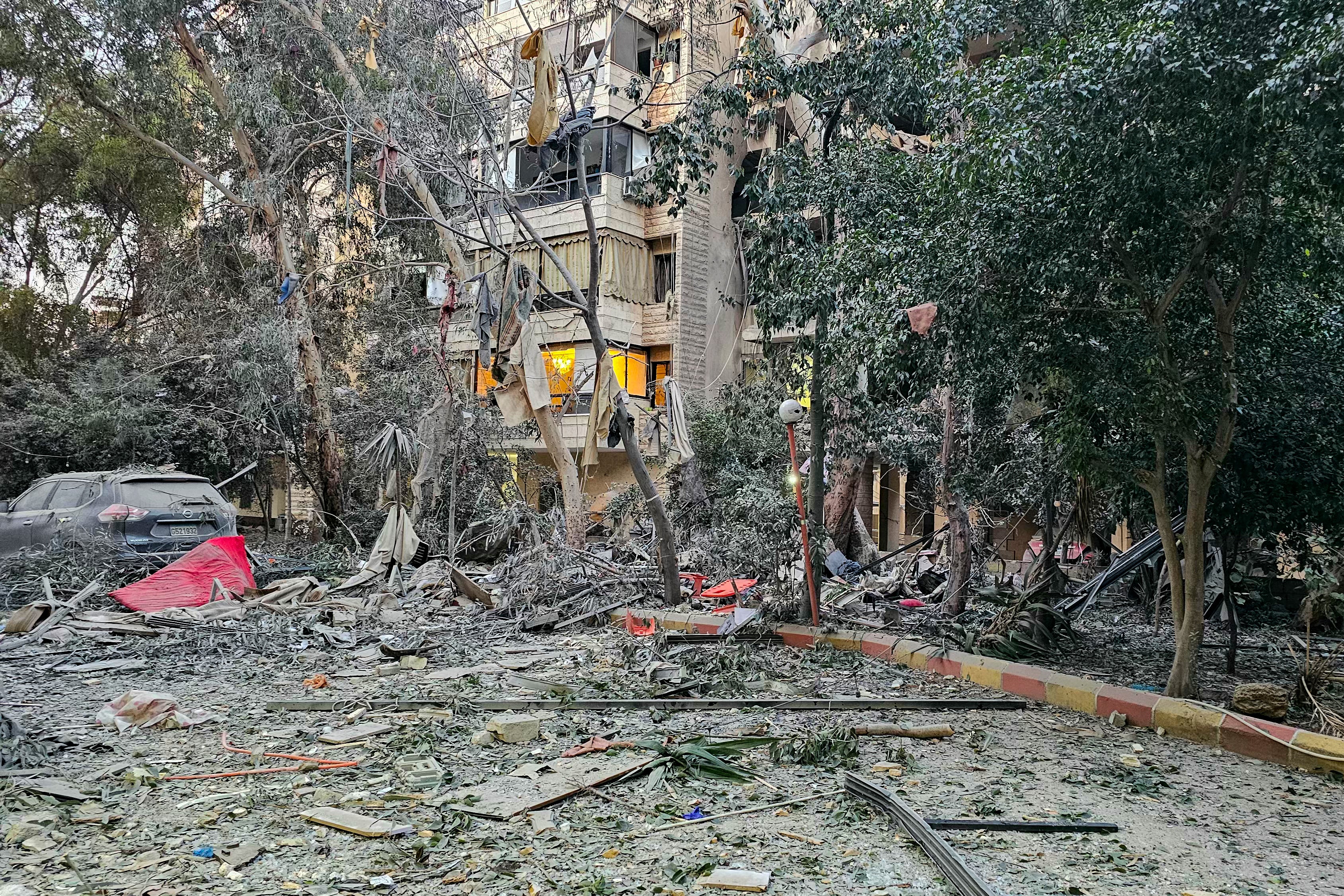 Debris is seen around a building damaged after an Israeli airstrike in Beirut's southern suburb neighborhood of Haret Hreik on Monday.