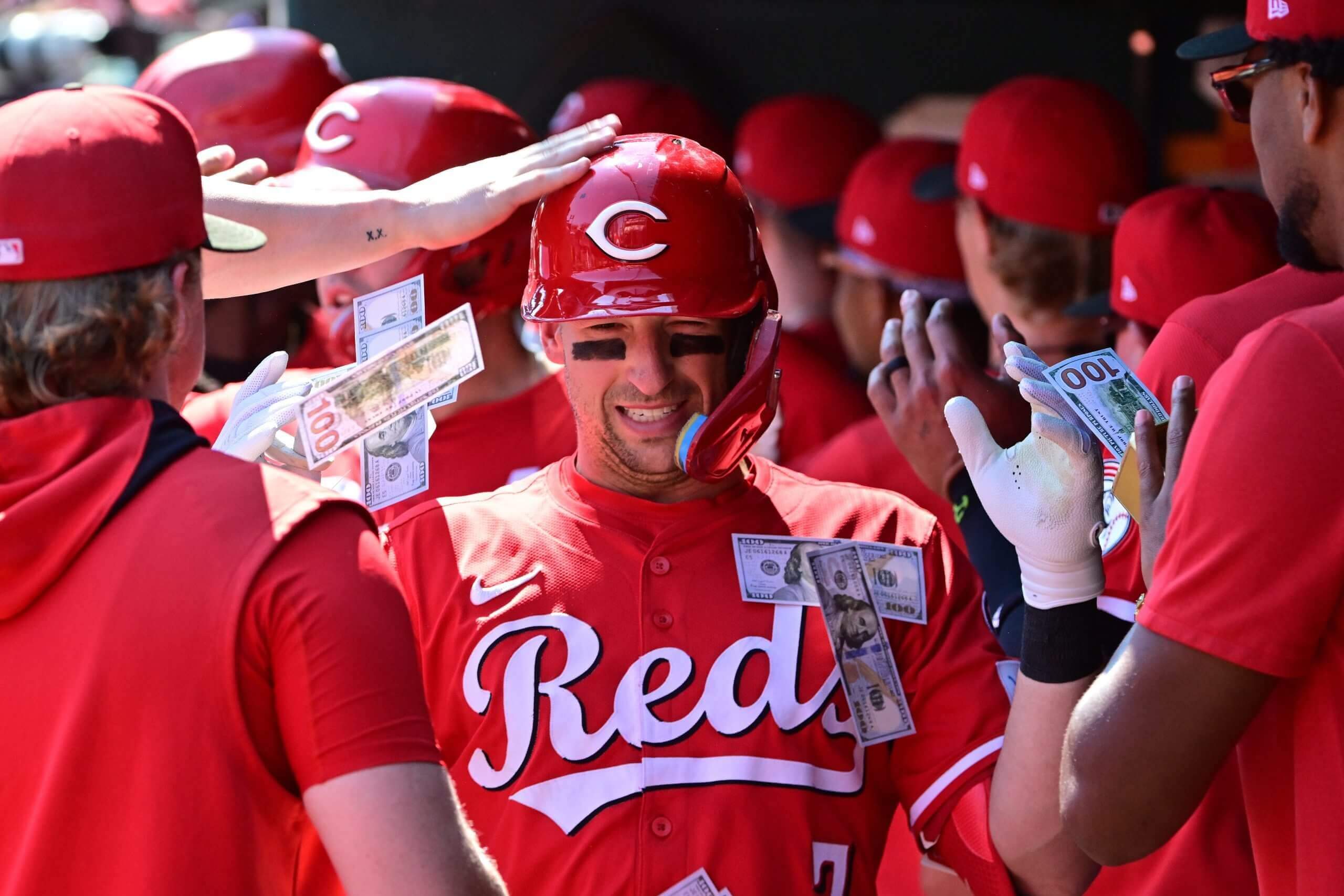 Cincinnati Reds teammates shower Cincinnati Reds first baseman Spencer Steer (7) with money in the dugout after he hit a three-run home run against the St. Louis Cardinals at Busch Stadium.