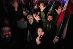 Government supporters chant slogans as they gather in mourning after state TV officially announced the death of Iranian Supreme Leader Ayatollah Ali Khamenei, in Tehran, Iran, Sunday, March 1, 2026
