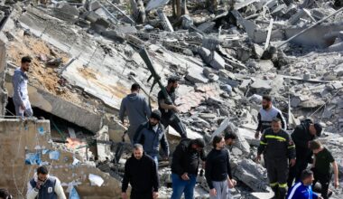 First aid responders and people gather at the site of an Israeli airstrike that targeted a building in the southern Lebanese village of Sarafand on March 27, 2026. Hezbollah said on March 27 its fighters had clashed directly with Israeli forces in two south Lebanon villages, as Israeli airstrikes across the region killed at least six people, according to the health ministry. Lebanon was pulled into the Middle East war when Tehran-backed militant group Hezbollah fired rockets towards Israel on March 2 to avenge the US-Israeli killing of Iran's supreme leader Ayatollah Ali Khamenei.