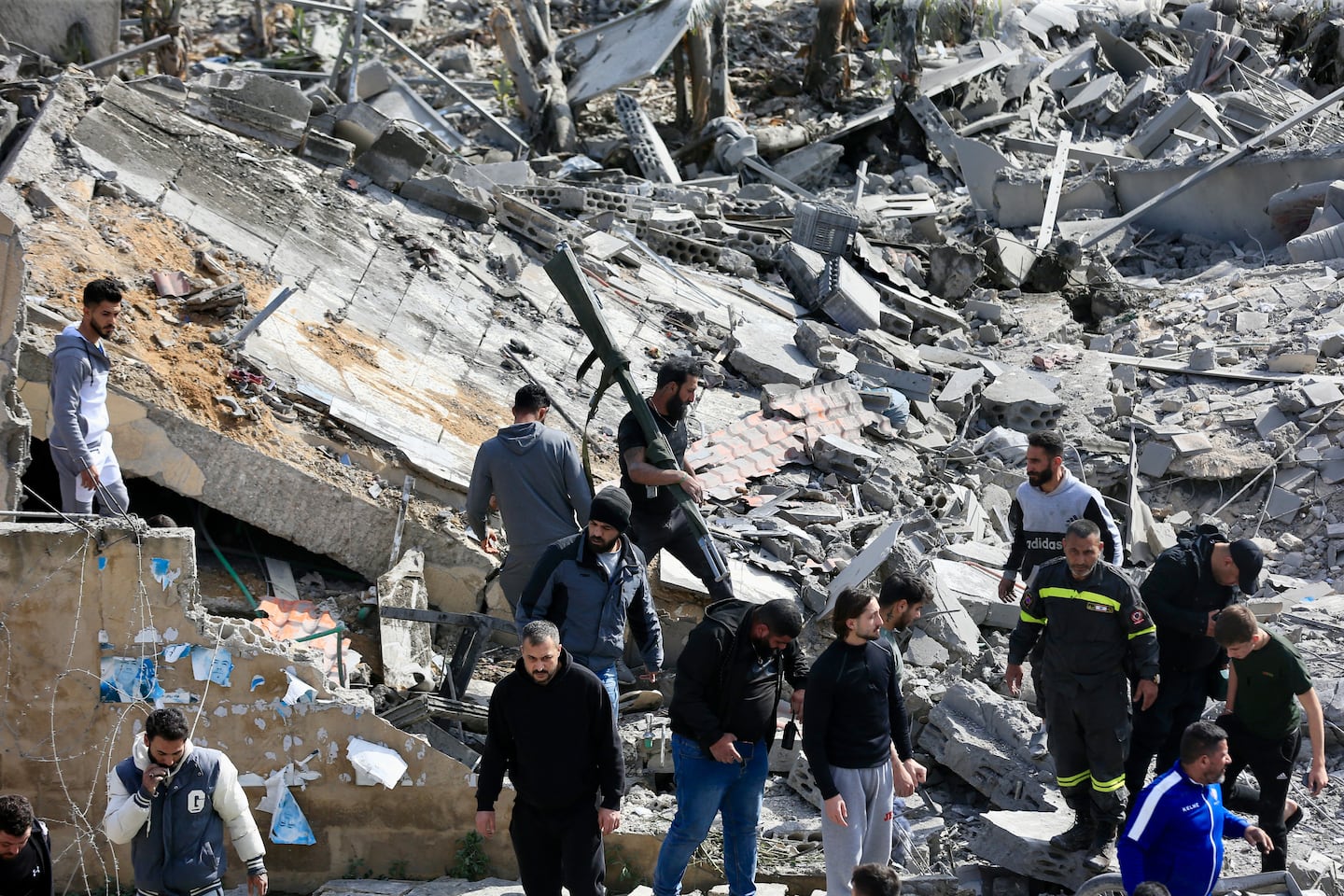 First aid responders and people gather at the site of an Israeli airstrike that targeted a building in the southern Lebanese village of Sarafand on March 27, 2026. Hezbollah said on March 27 its fighters had clashed directly with Israeli forces in two south Lebanon villages, as Israeli airstrikes across the region killed at least six people, according to the health ministry. Lebanon was pulled into the Middle East war when Tehran-backed militant group Hezbollah fired rockets towards Israel on March 2 to avenge the US-Israeli killing of Iran's supreme leader Ayatollah Ali Khamenei.