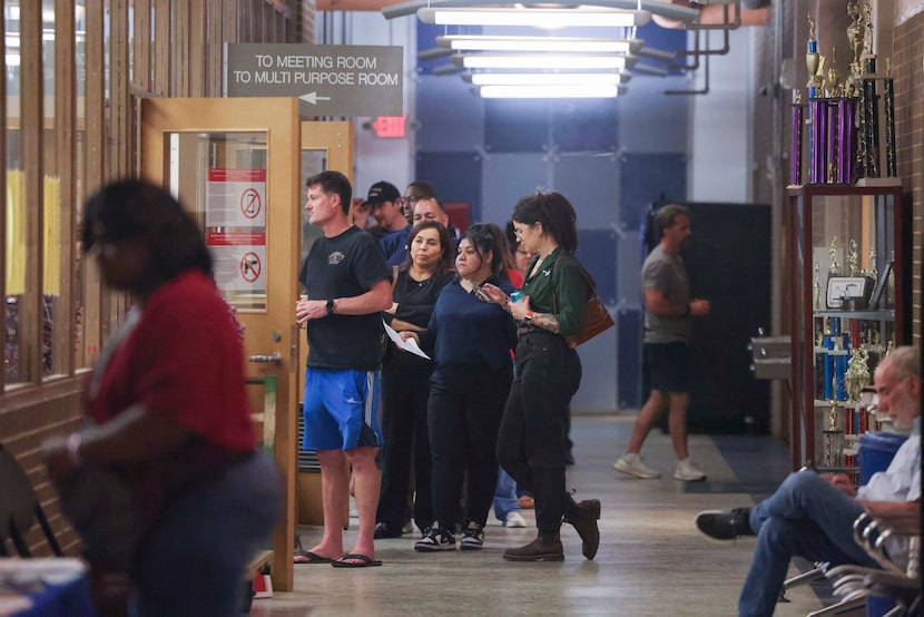 Residents wait in line to cast their votes past 10 p.m during primary election night, on...