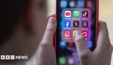 Generic image of a school child using a smartphone to look at social media