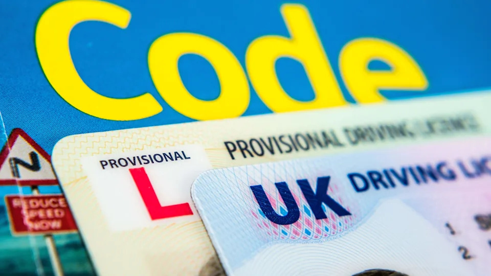 UK Driving Licence. Provisional and Full licence cards placed on Highway Code book. Macro. Stafford, United Kingdom, January 30, 2022.