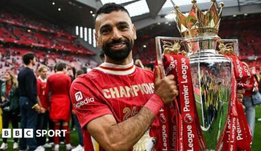 Mohamed Salah poses with the Premier League trophy