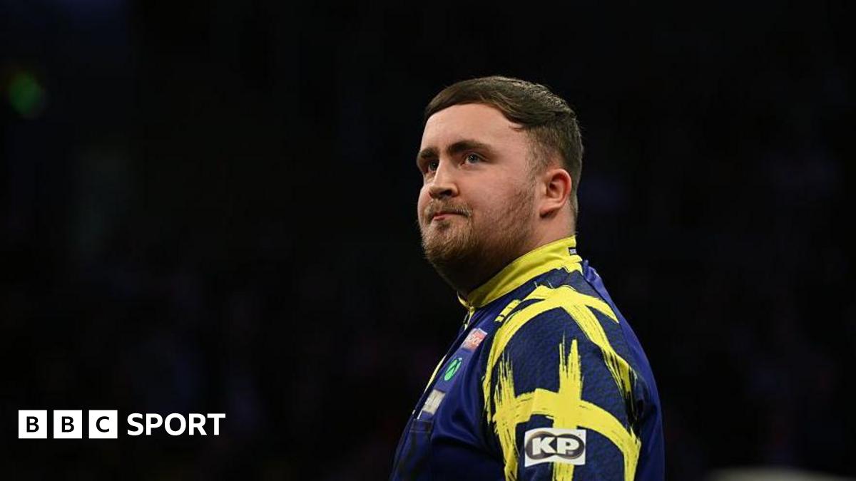 Stock image of Luke Littler. He is looking into the distance.